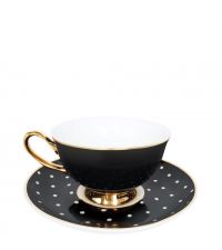 schwarze Teetasse und Teller mit Punkten