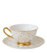 weiße Teetasse und Untersetzer mit Goldtupfen und goldenen Elementen